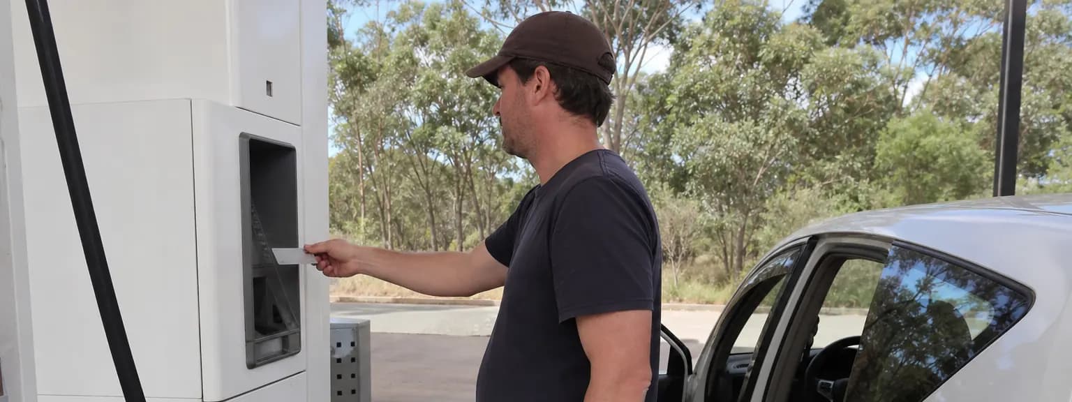 Driver using one payment card at an unbranded Australian fuel pump while the car is being filled